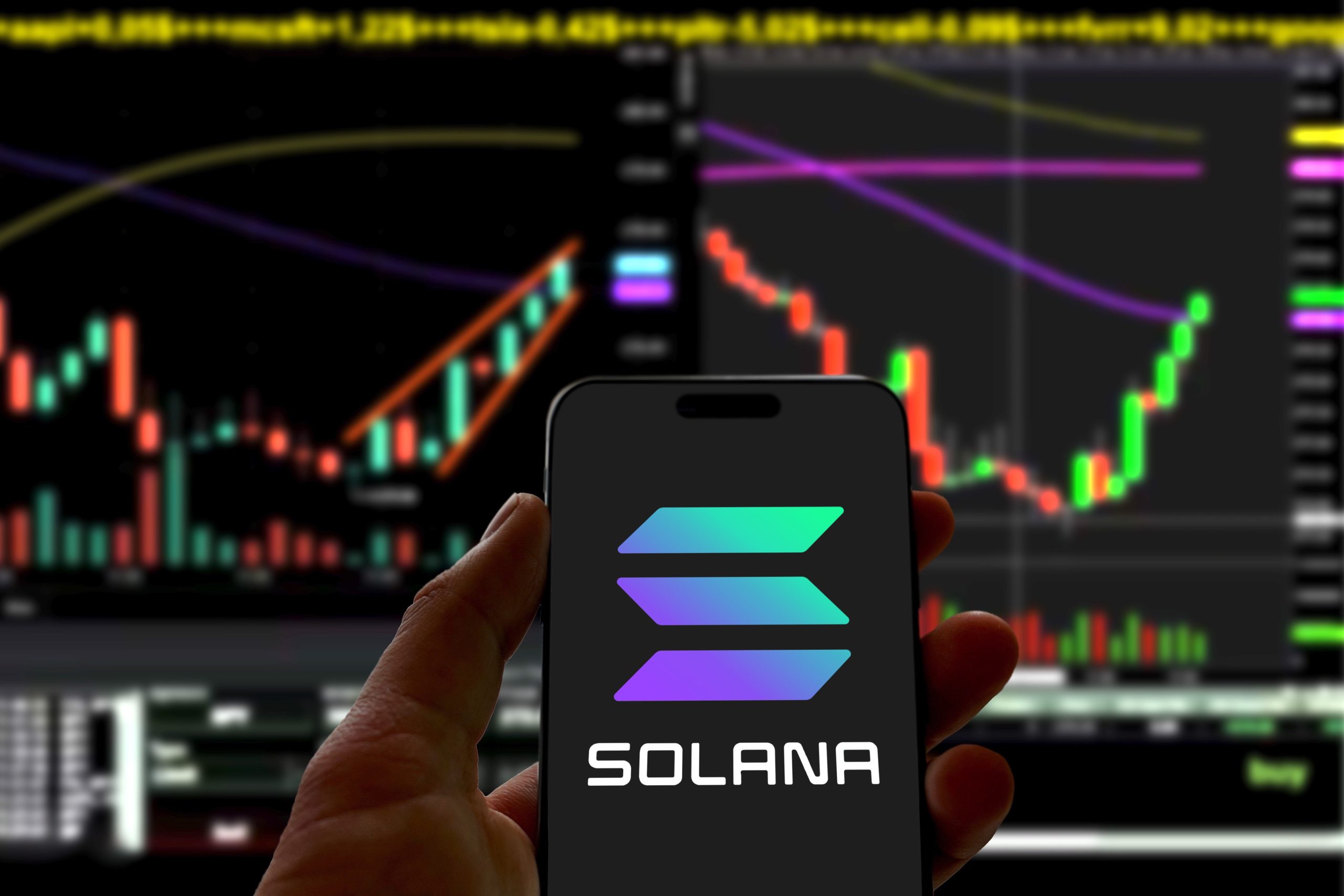 The Solana logo displayed on a phone with charts in the background, a reminder of early projects that once delivered outsized returns.
