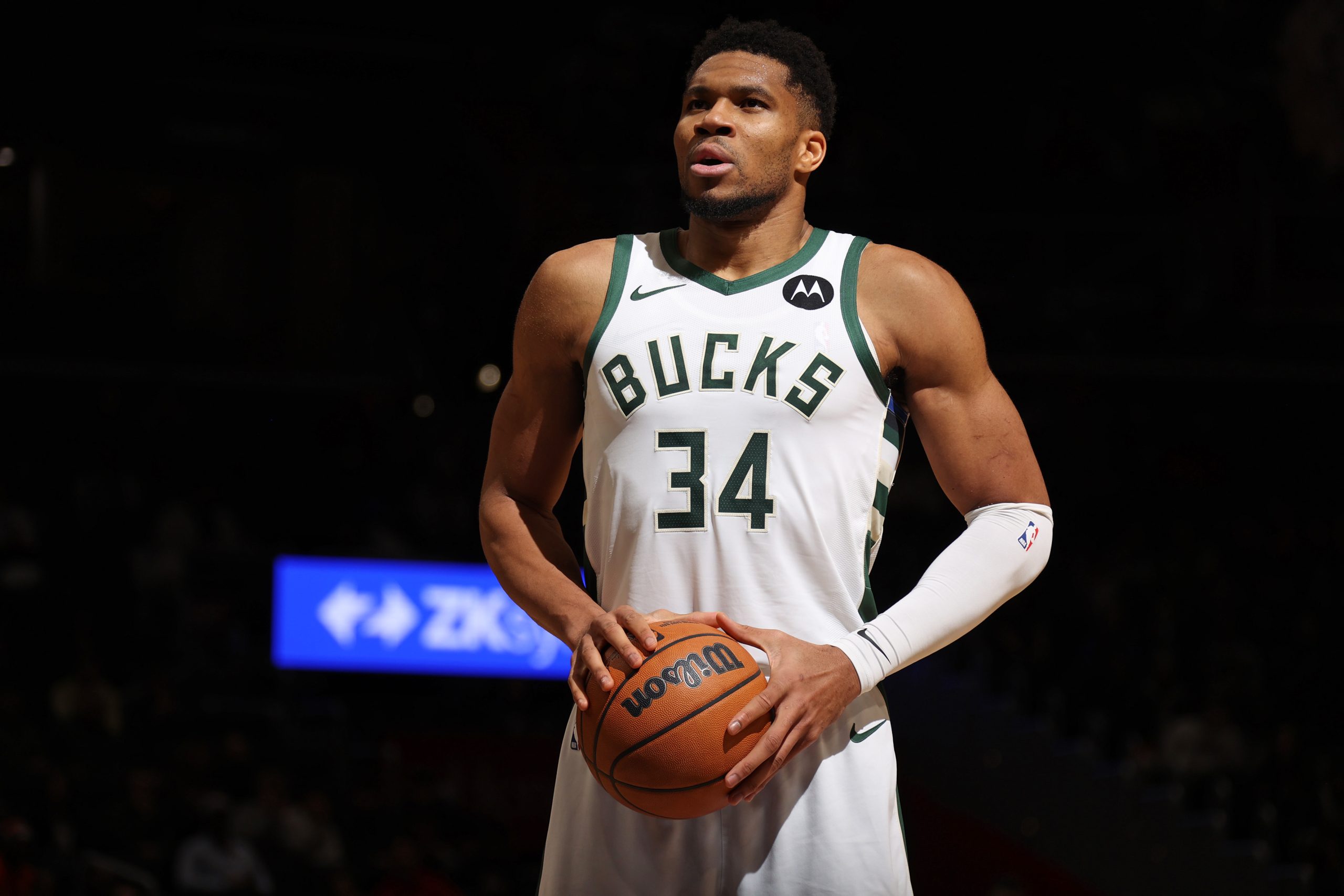 Milwaukee Bucks player Giannis Antetokounmpo holding a basketball.