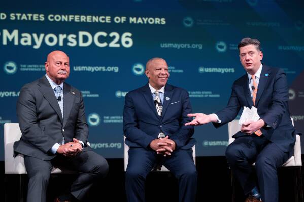 Oklahoma City Mayor David Holt, right, speaks during a panel discussion with Fresno, Calif. Mayor Jerry Dyer, left, and Omaha, Neb. Mayor John Ewing, Jr. during the 94th Winter Meeting of the U.S. Conference of Mayors, Wednesday, Jan. 28, 2026 in Washington. (AP Photo/Kevin Wolf)