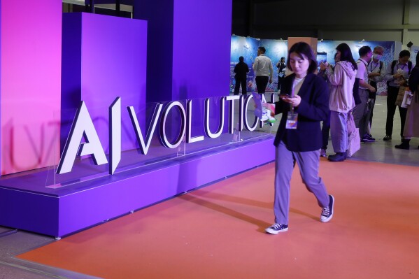 FILE -People visit the AI EXPO Taiwan exhibition ''AIVOLUTION'' in Taipei, Taiwan, April 25, 2024. (AP Photo/Chiang Ying-ying, File)