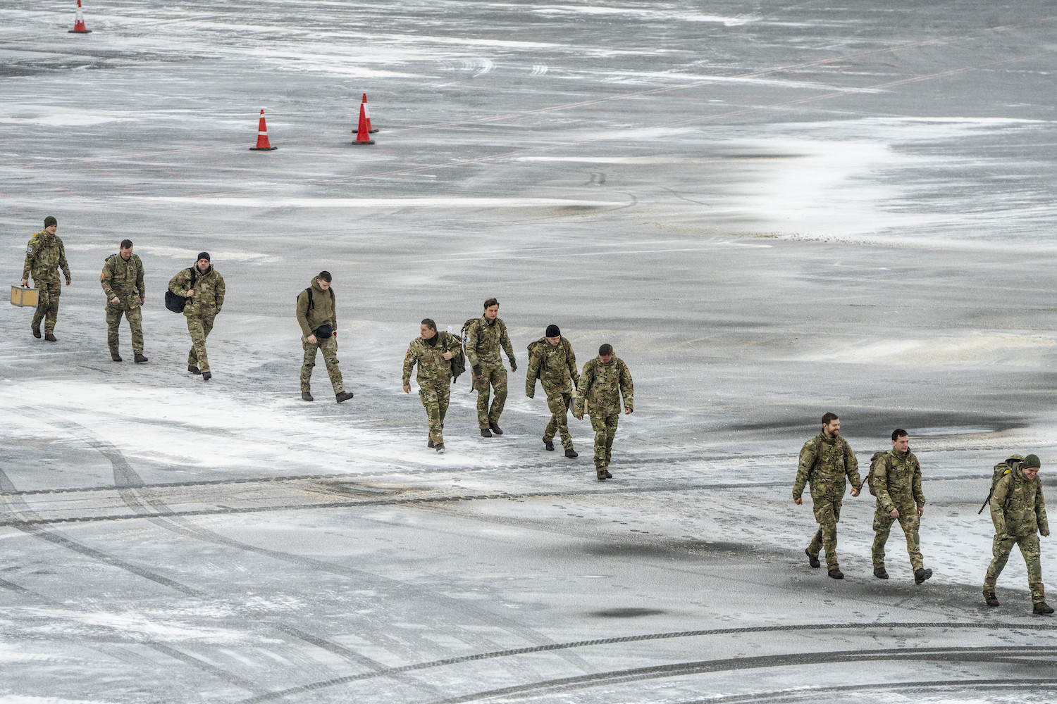 Danish soldiers walk across the frozen tarmac after arriving at Nuuk Airport in Greenland.