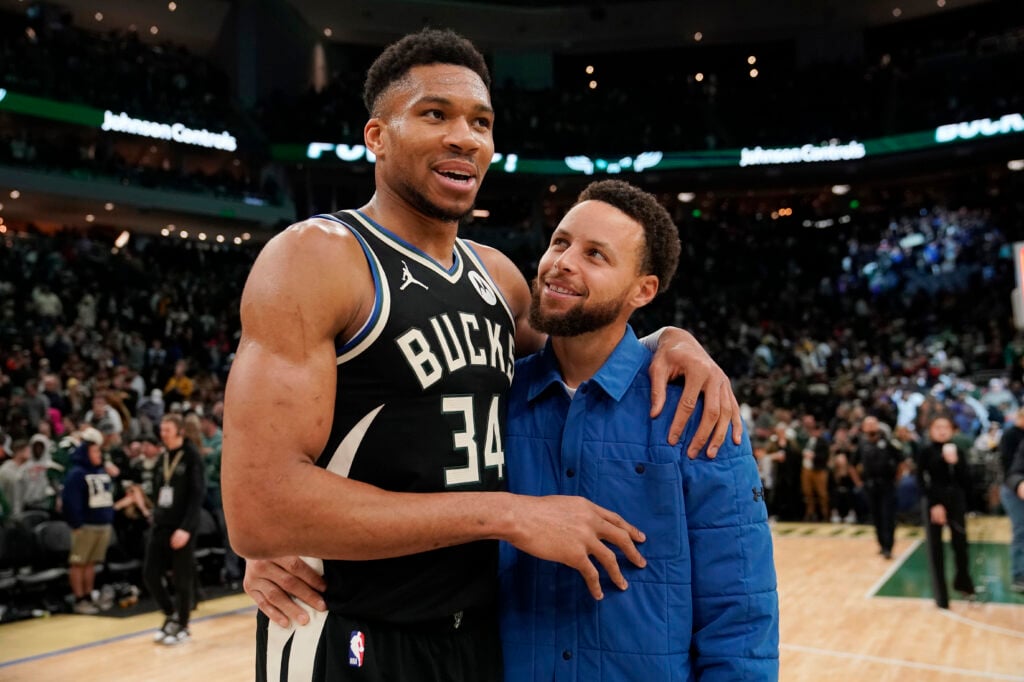Giannis Antetokounmpo #34 of the Milwaukee Bucks and Stephen Curry #30 of the Golden State Warriors talk after a game at Fiserv Forum on January 13, 2024 in Milwaukee, Wisconsin.