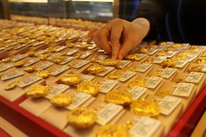 A worker arranges gold jewelry at a store in China on Jan. 26, 2026.
