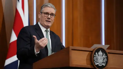 Reuters Keir Starmer stands in the Downing Street briefing room.