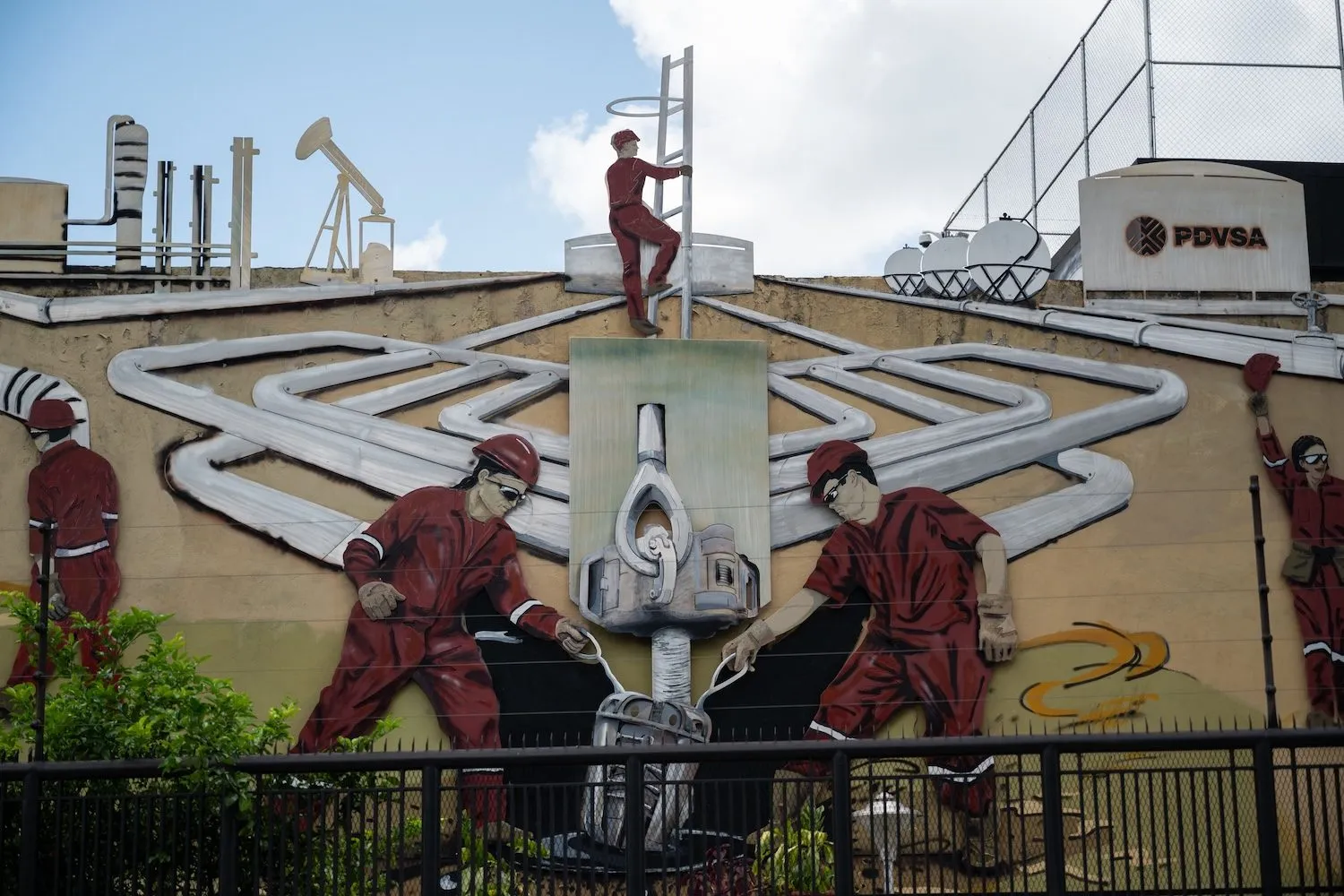 A mural at the PDVSA headquarters shows men working at Venezuela's oil refineries, in Caracas, on September 13, 2023.