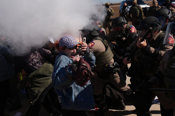 Pepper spray is used by Texas troopers to disperse protesters outside the South Texas Family Residential Center detention facility where Liam Ramos and his father are being detained in Dilley, Texas, Wednesday, Jan. 28, 2026. (AP Photo/Eric Gay)