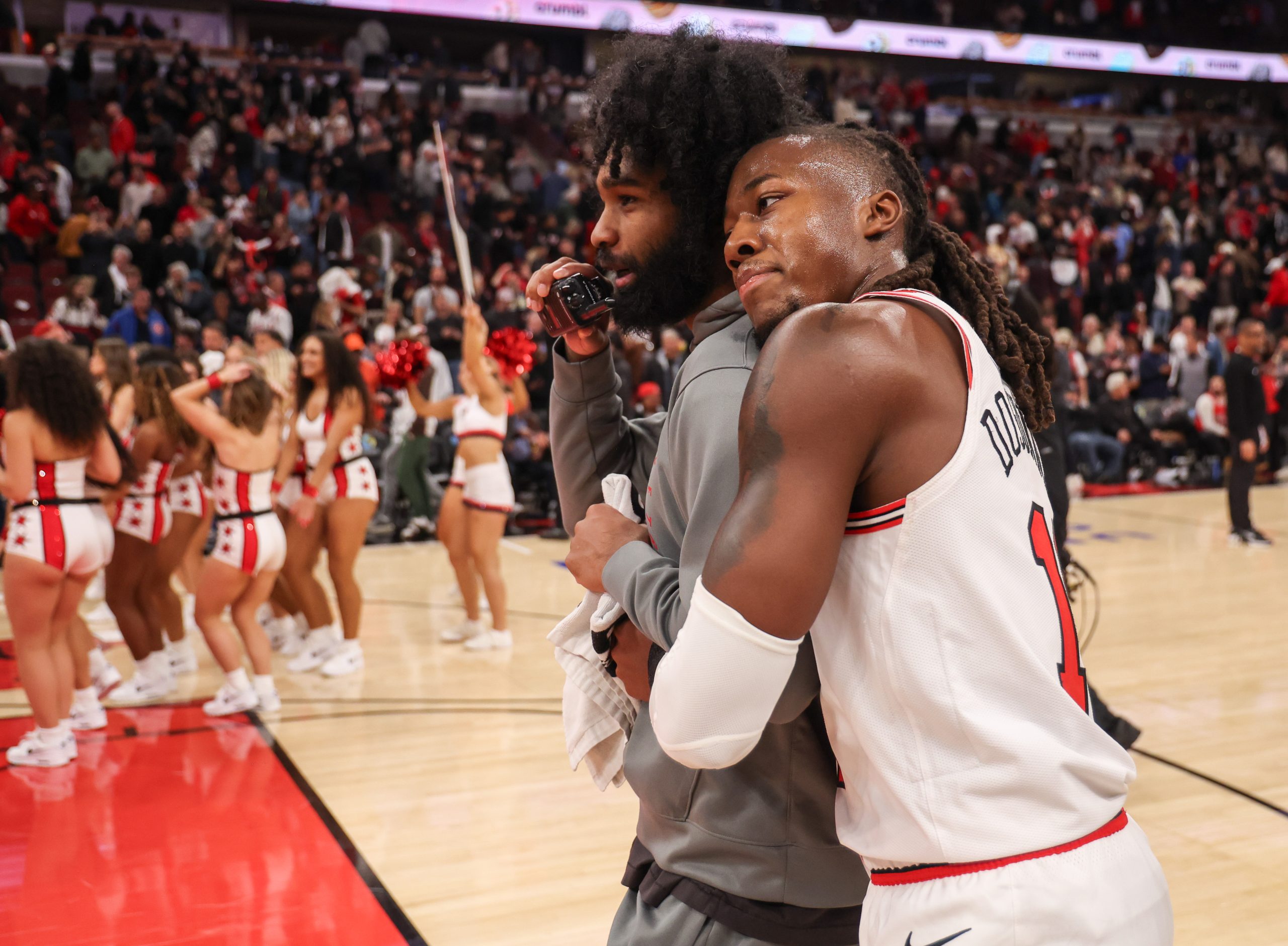 Chicago Bulls guard Ayo Dosunmu (11) hugs Chicago Bulls guard...