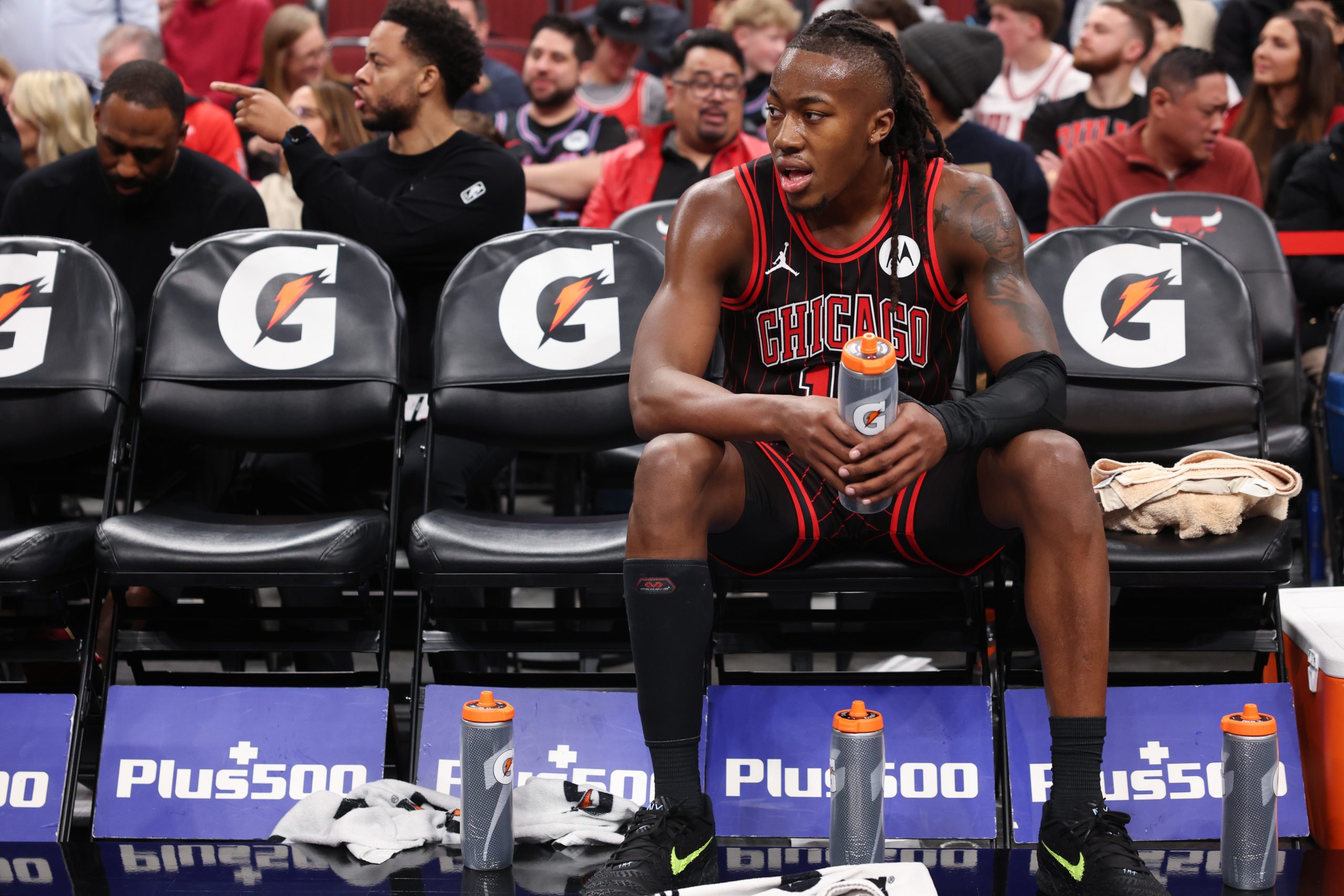 Bulls guard Ayo Dosunmu rests on the bench during a...
