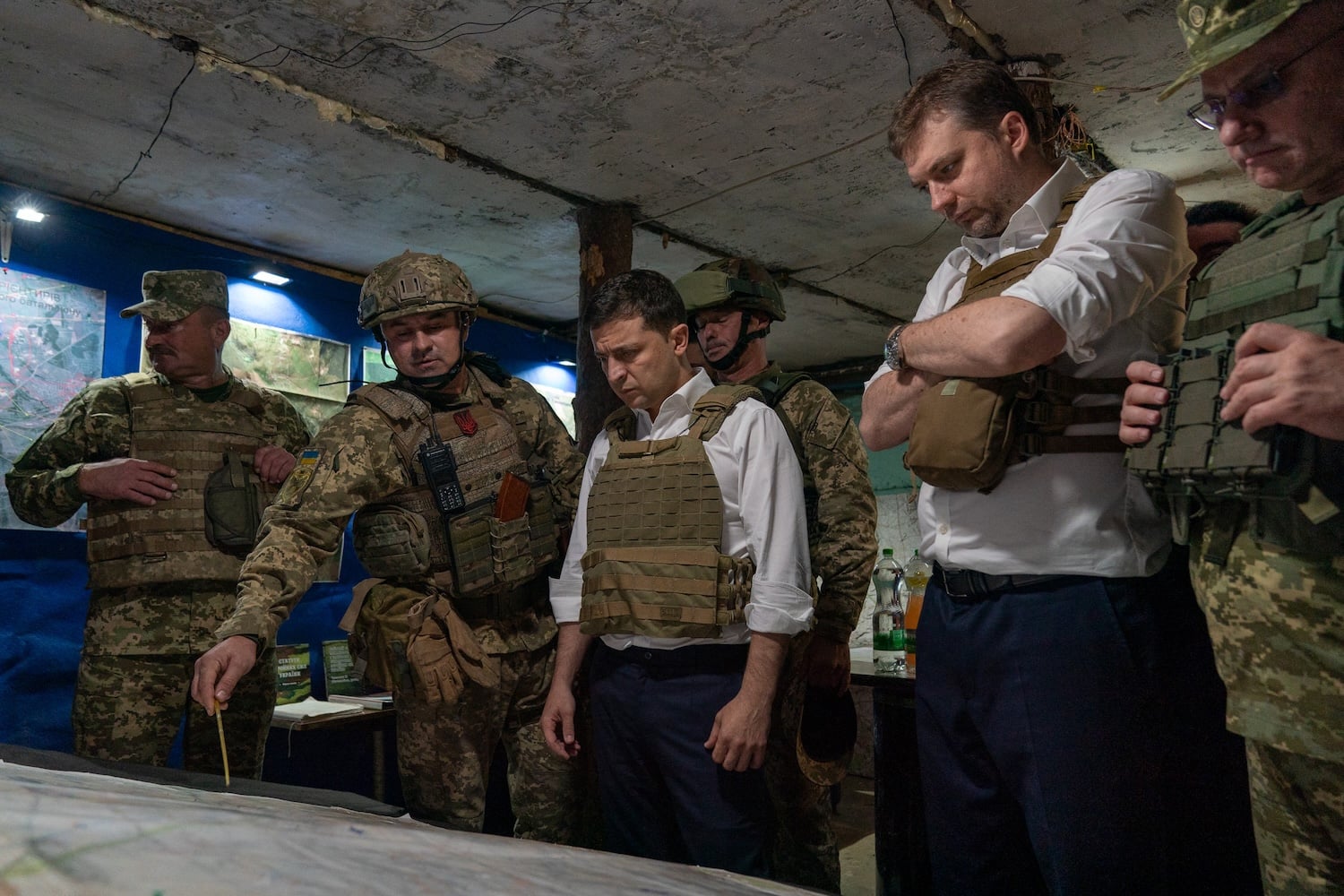 Ukrainian President Volodymyr Zelensky talking with officers at a map during his visit to the Donetsk region on October 14, 2019.