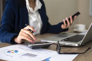 Close up of female accountant or banker making calculations