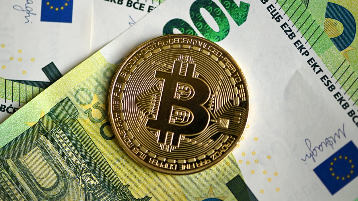 A commemorative Bitcoin coin is pictured on 100 euros notes in Dortmund, western Germany