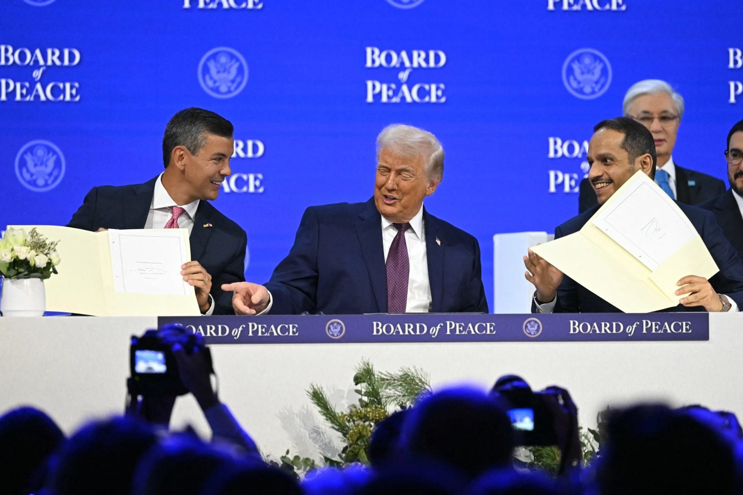 Paraguayan President Santiago Peña, U.S. President Donald Trump, and Qatari Prime Minister Sheikh Mohammed bin Abdulrahman bin Jassim Al Thani participate in the signing ceremony of the Board of Peace in Davos, Switzerland on Jan. 22.